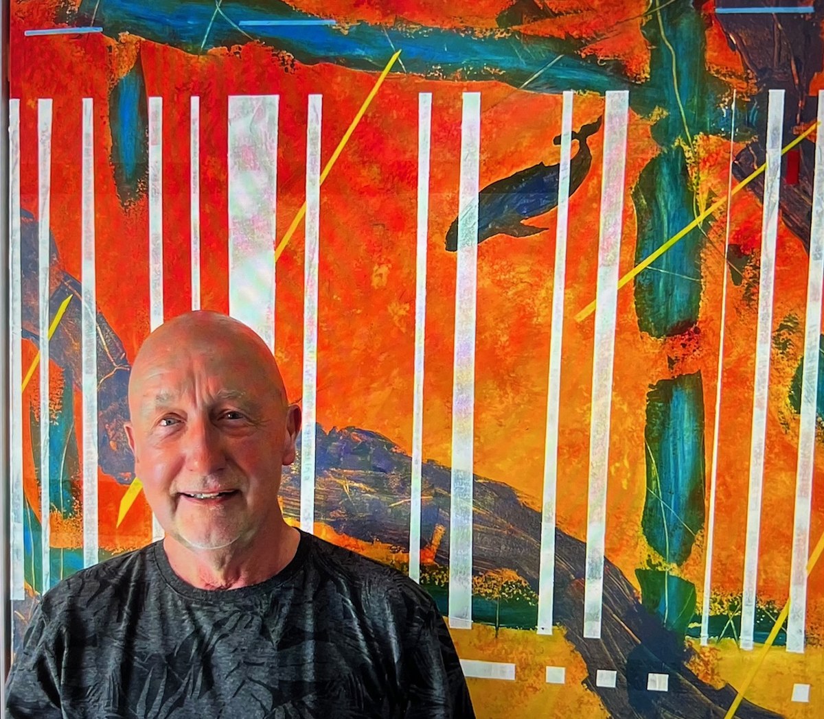 Buck (Ian Hervé Buchanan), Brighton-based abstract painter, standing in front of one of his original paintings